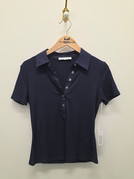Navy polo with text on a hanger against a white background