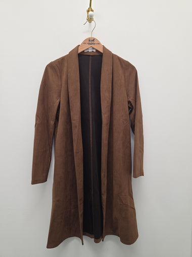 A brown suede-like open-front coat or robe hanging on a wooden hanger against a plain light gray wall.