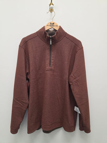 A rust-brown heathered quarter-zip pullover sweatshirt hanging on a wooden hanger against a plain off-white wall.