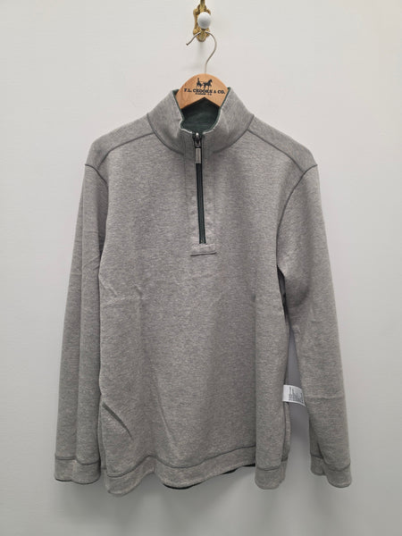 A heather gray quarter-zip pullover sweatshirt hanging on a wooden hanger against a plain light gray wall.