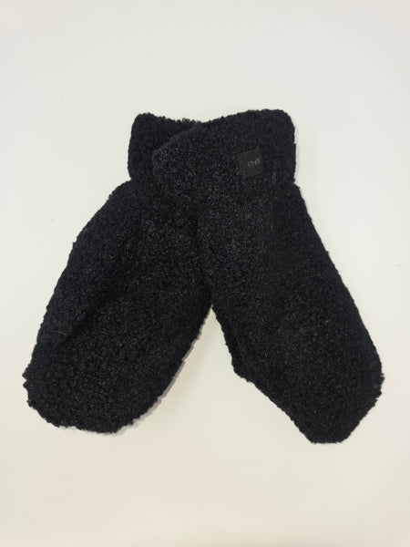 Black fleece mittens with a soft, textured sherpa-like finish, laid flat on a light off-white background.