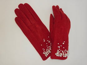 A pair of red suede gloves decorated with white faux pearls at the cuffs, displayed on a plain light background.