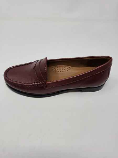 A single women's penny loafer in burgundy leather, shown from a side profile view on a light gray background.