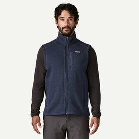 Man wearing a blue fleece vest with a brand logo on a white background