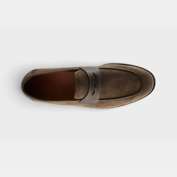 A single brown suede penny loafer shown in profile against a light gray background.