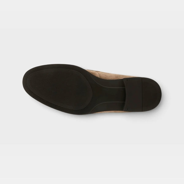 Top-down view of a shoe sole, showing a black rubber treaded outsole with a metallic silver upper.