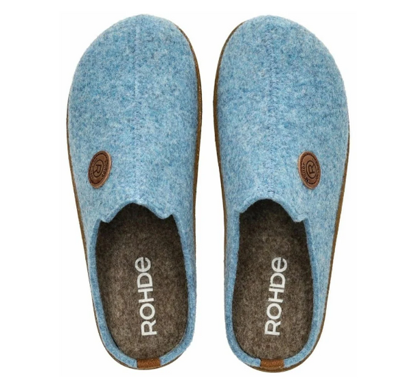 A pair of light blue felt slip-on slippers with brown circular logo details and a dark brown felt interior, shown from a top-down view on a white background. The brand name 'ROHDE' is printed in white on the insole.