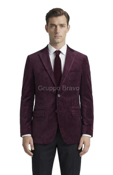 A man modeling a dark plum velvet blazer with a white dress shirt and a matching dark plum tie, set against a plain white background. A semi-transparent 'Gruppo Bravo' watermark is visible across the chest.
