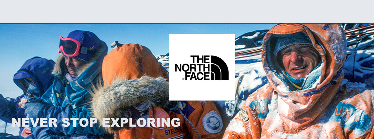 Slider of four men in the snow wearing The North Face hooded jackets