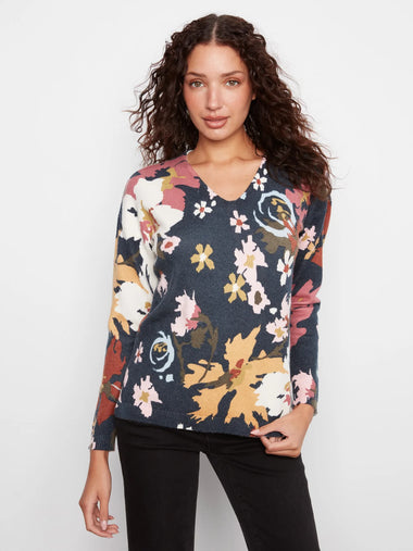 Woman wearing a floral sweater on a white background