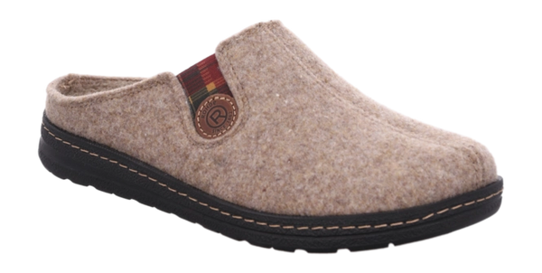 A single slip-on felt clog shoe in a light beige/tan color, featuring a black sole with light tan contrast stitching and a small decorative striped fabric tag with a circular logo patch.